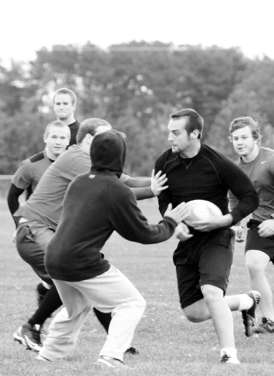 In a team scrimmage Chris Konieczka carries the ball into a crowd.