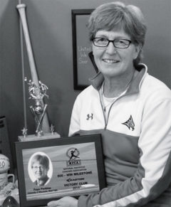 Head Coach Faye Perkins showcases memorabilia from past seasons. Perkins is set to retire after this season.