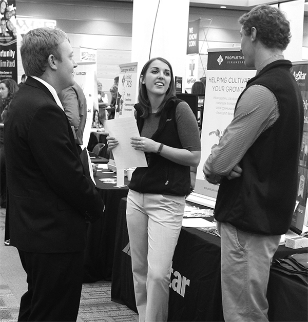 Agricultural business student Daniel Gerlach speaks to Resha Koster and Mike Kline from AgStar.