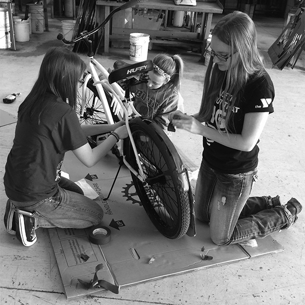 River Falls High School National Honor Society students help fix up the donated bikes for the Blue Bike Program.