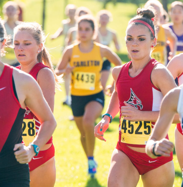 Linsey Tolkkinen, left, and Abby Fouts run at the Falcon Invitational on Sept. 8. Photo by Tori Schneider