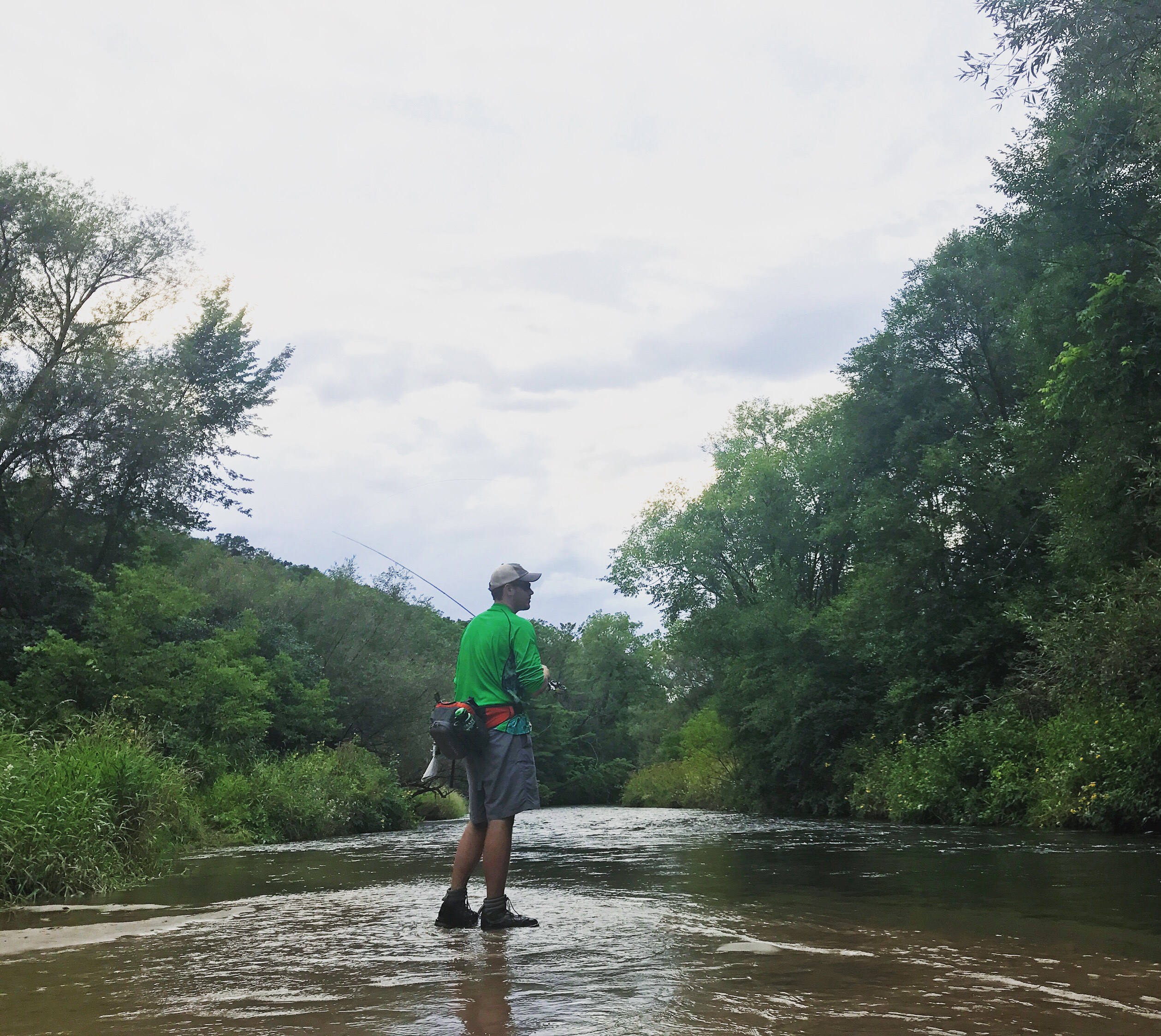 Cody Rajewski, of Bay City, MI, fly fishes on the Kinnickinnic River, August 5. Photo by Tori Schneider/Student Voice