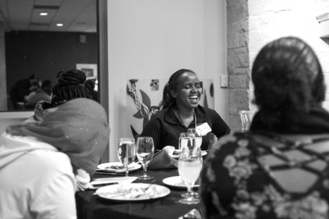 Ibrahim laughs with others during an Aspire event in the University Center.