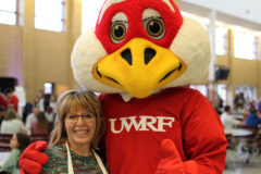 Mary Van Galen poses with Freddy the Falcon during the Relay for Life event at the River Falls High School last Friday.