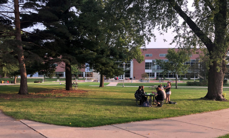 During a recent evening at dinner time, students socially distance outside University Center on the UW-River Falls campus. (Photo by Theodore Tollefson)